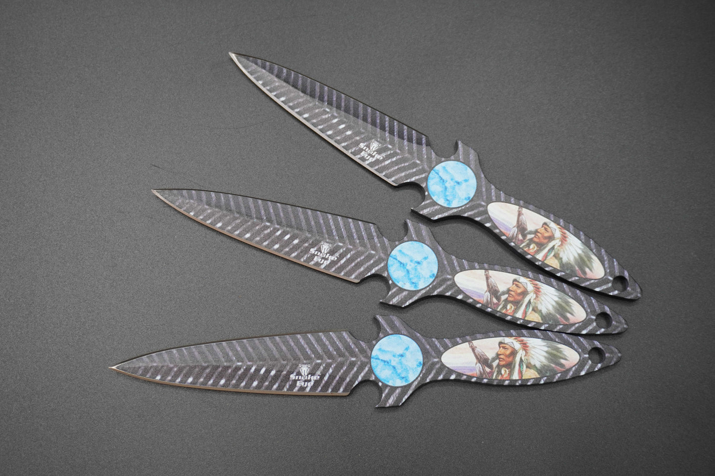 Four Decorative knives with gemstone handles on a gray background