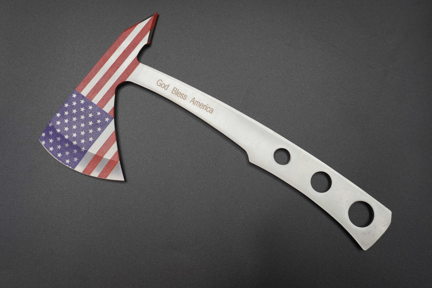 Axes with American Flag Blade and Engraved Text on a Dark Background