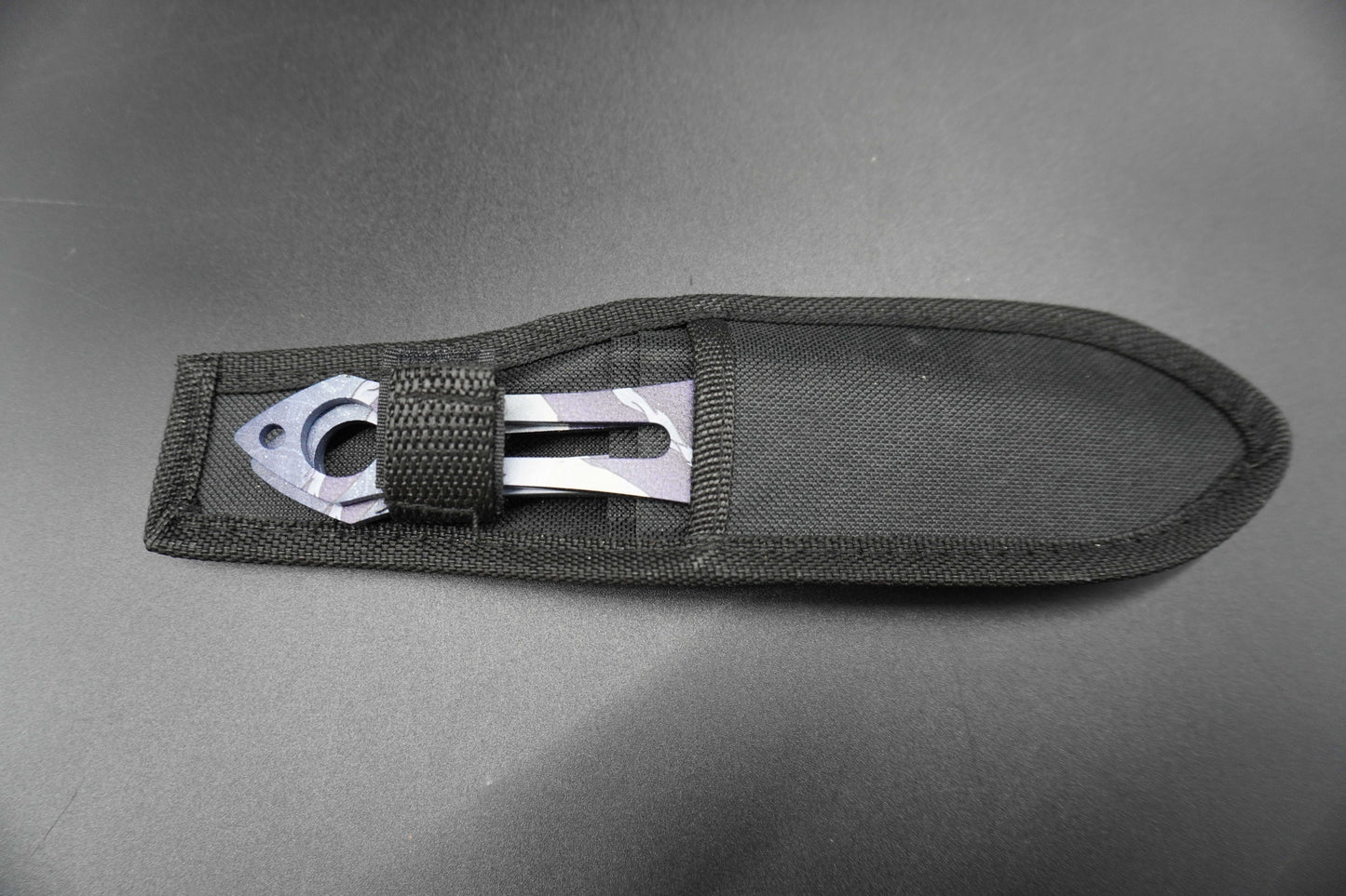 Black sheath with metal clip on a gray background