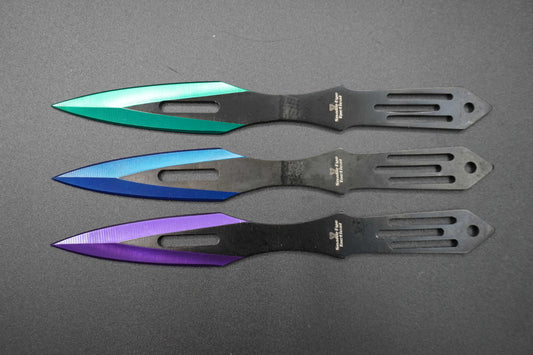 Three colorful throwing knives on a gray background