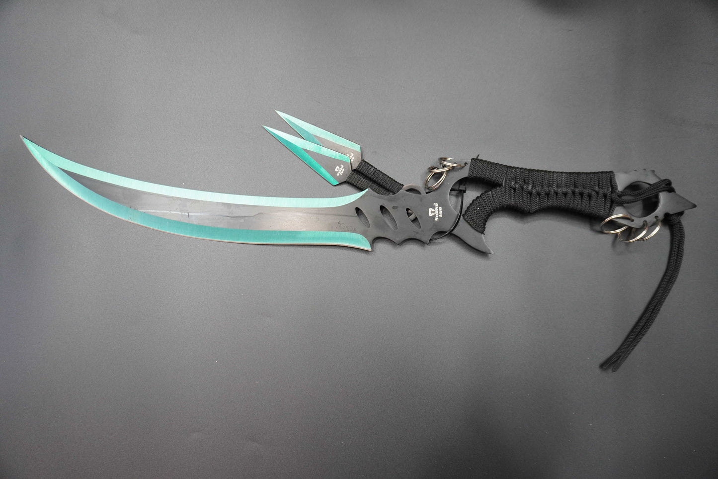 Futuristic sword with a black and gray handle and green blade on a gray background