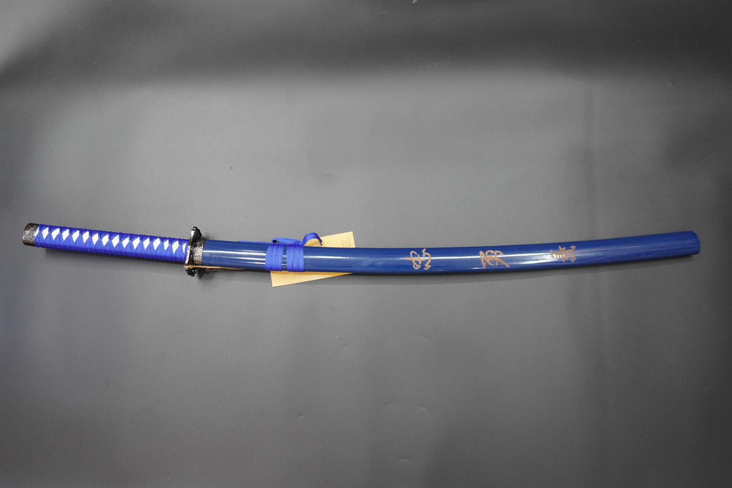 Blue sword with decorative patterns on a gray background
