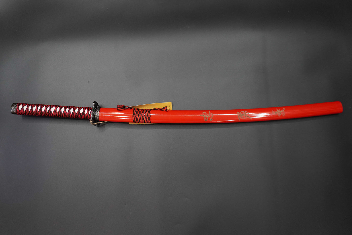 Red sword with decorative patterns on a gray background