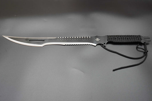 Forked blade knife with black handle on a gray background