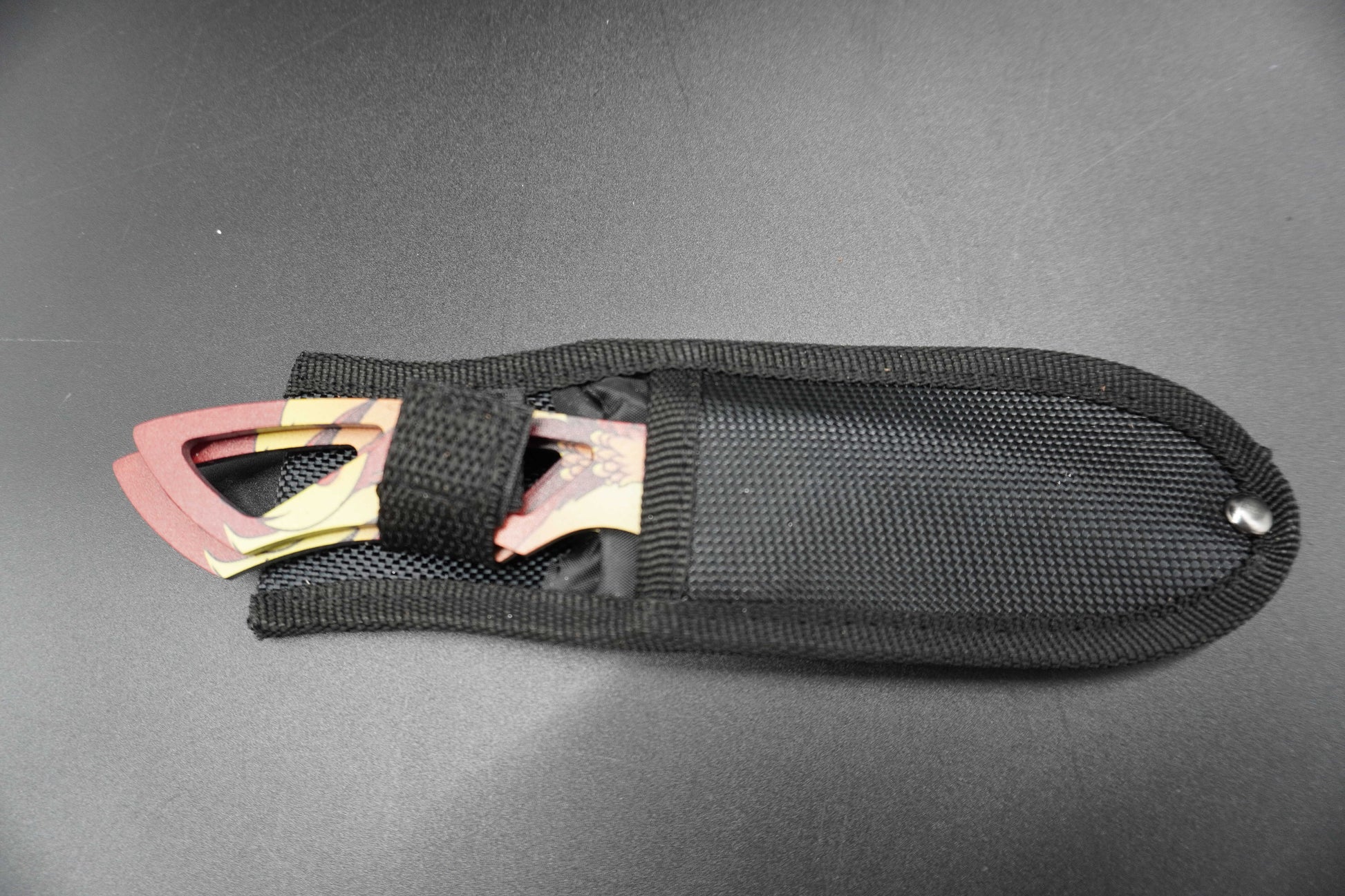 Black sheath with a knife blade on a gray background