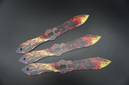 Three decorative paper blades with intricate patterns on a dark background